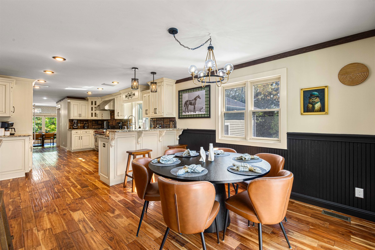 Kitchen with a casual dining table for 6 plus 4 bar seating. Just off the kitchen is the dining room with seating for 12-16. Kitchen also has sliding doors leading to the upper outdoor deck with outdoor seating for 12.