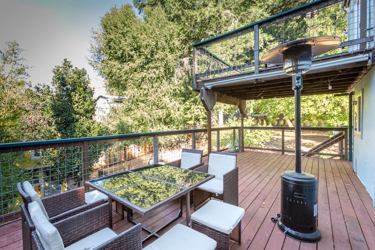 - Spacious deck with comfortable seating and glass top dining table for gatherings  
- Overhead balcony provides shade, while heater keeps evenings cozy outdoors  
- Enjoy serene views of surrounding trees and natural landscape from here  