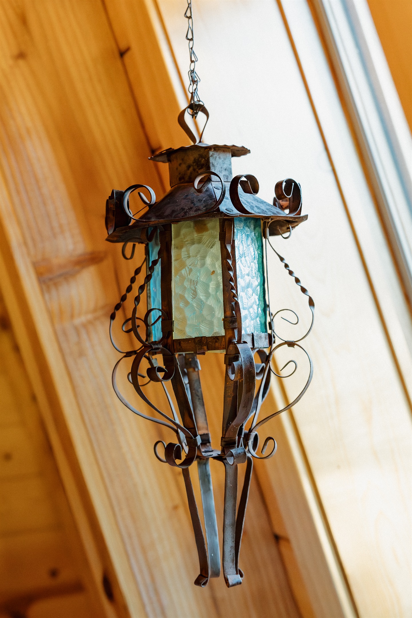 Handcrafted wrought iron lighting fixtures add authentic gothic western character throughout Poppywood Pines. This unique Show Low A-frame features artisan details and dramatic design elements, creating an unforgettable White Mountains vacation rental expe