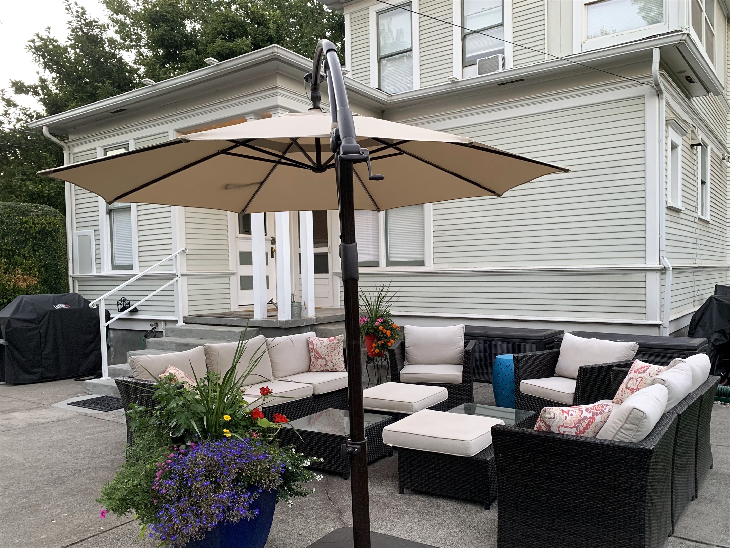 Back patio, surrounded by mature trees and historic charm and equipped with lounge seating and BBQ (propane provided)