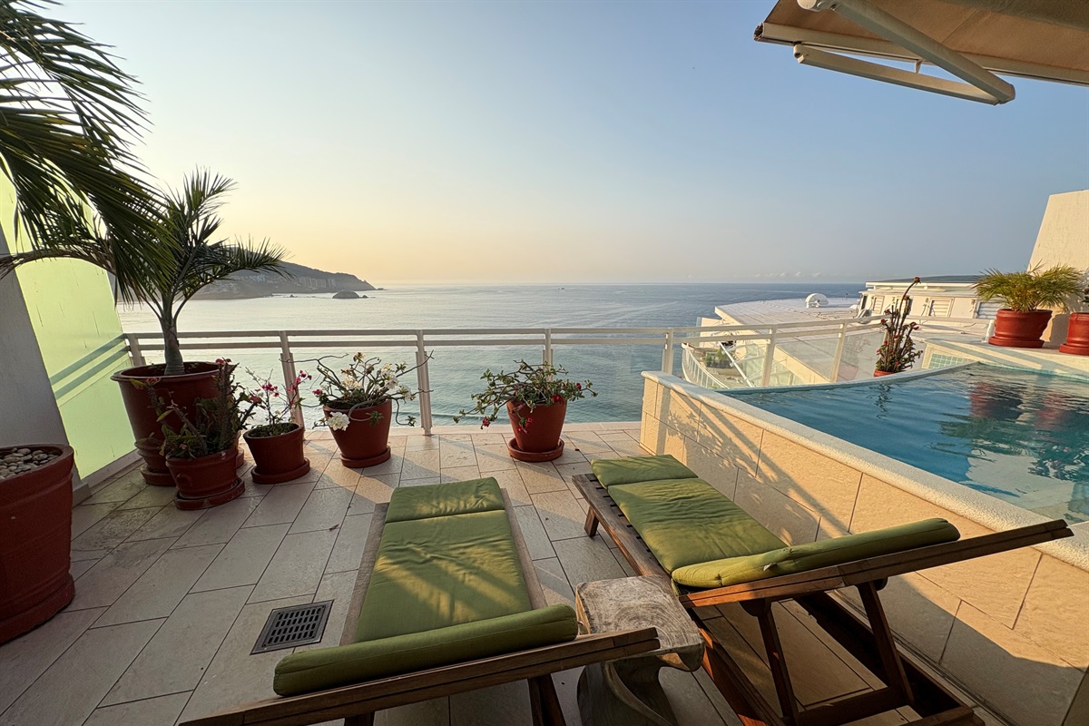 Lounge chairs on Patio by private pool