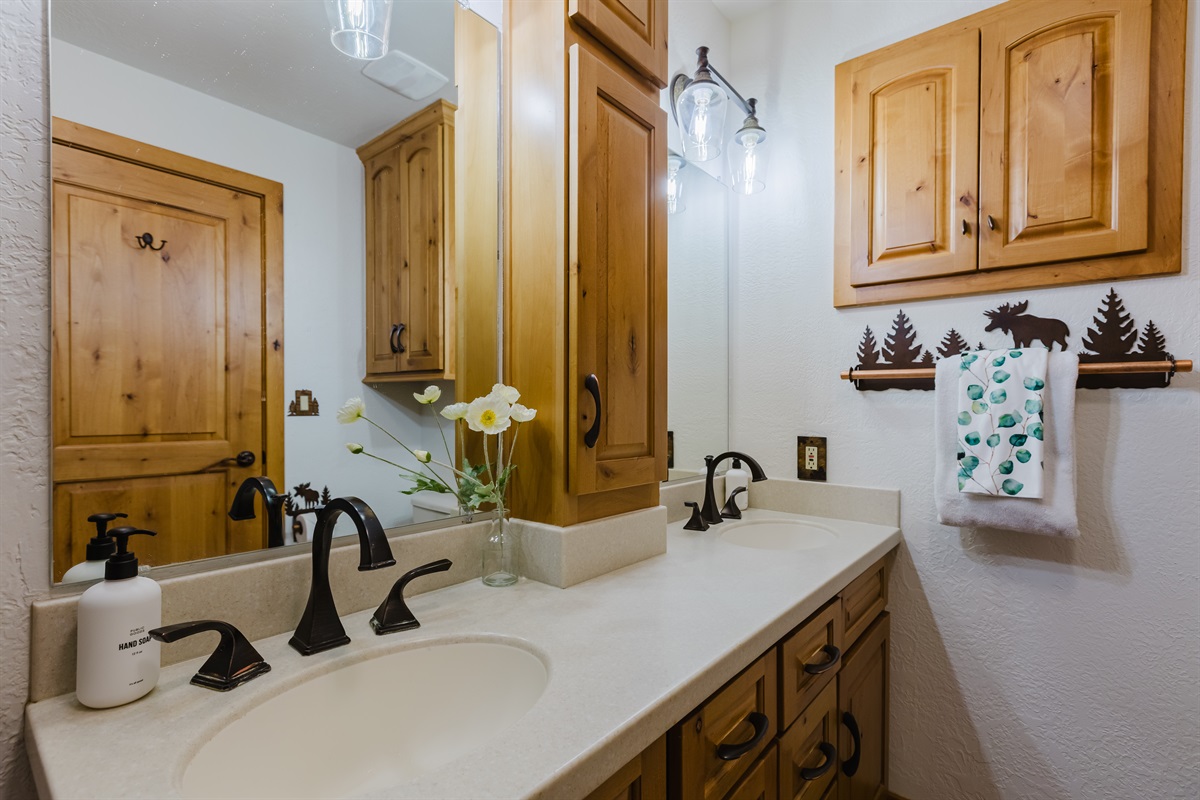 Step into the spacious shower or soak beneath soft lighting that echoes the serenity of the mountains outside.