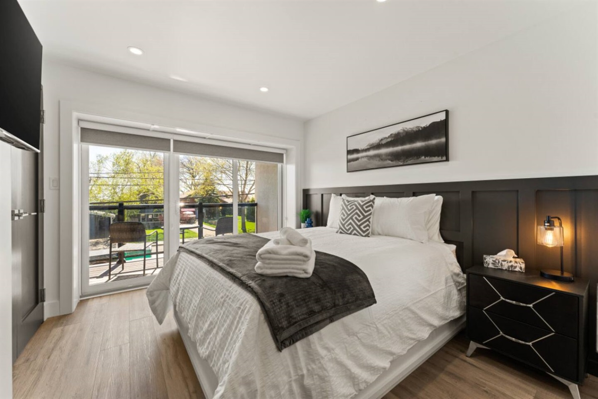 2nd floor Queen Bedroom with private balcony and modern minimalist design.