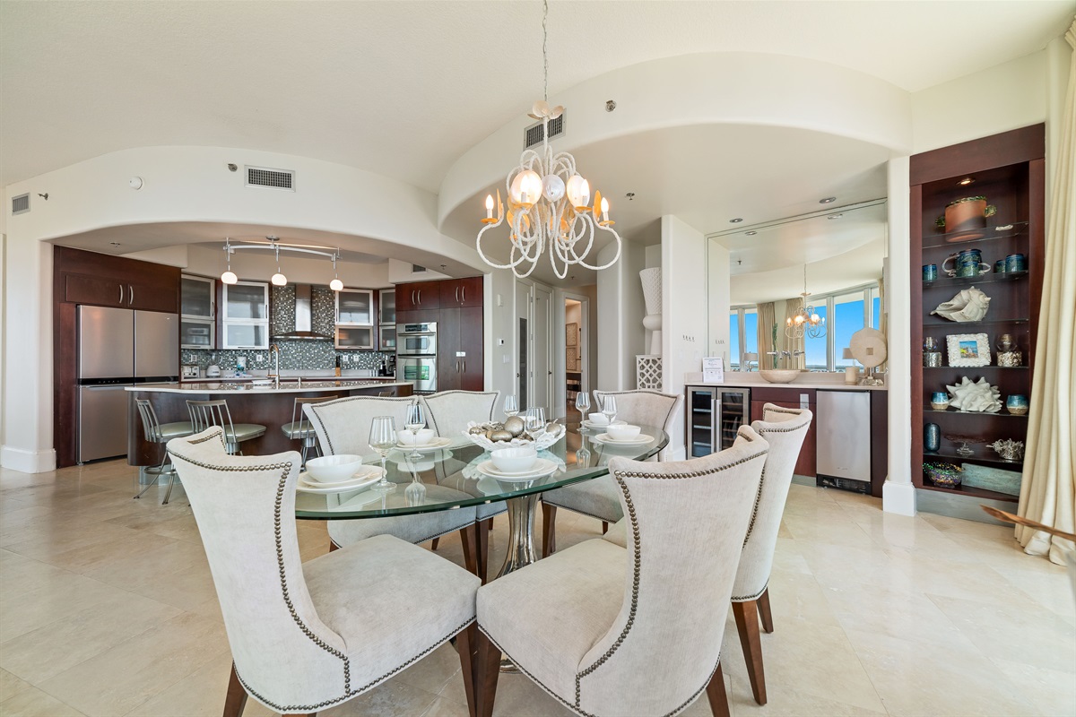 Dine in style with ample space for everyone. This inviting dining area features a charming table for family meals, complemented by additional seating at the convenient breakfast bar.