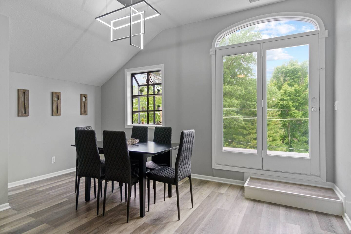 Elegant 6-seater dining area with a large window offering a beautiful nature view, perfect for enjoying meals in a tranquil setting.