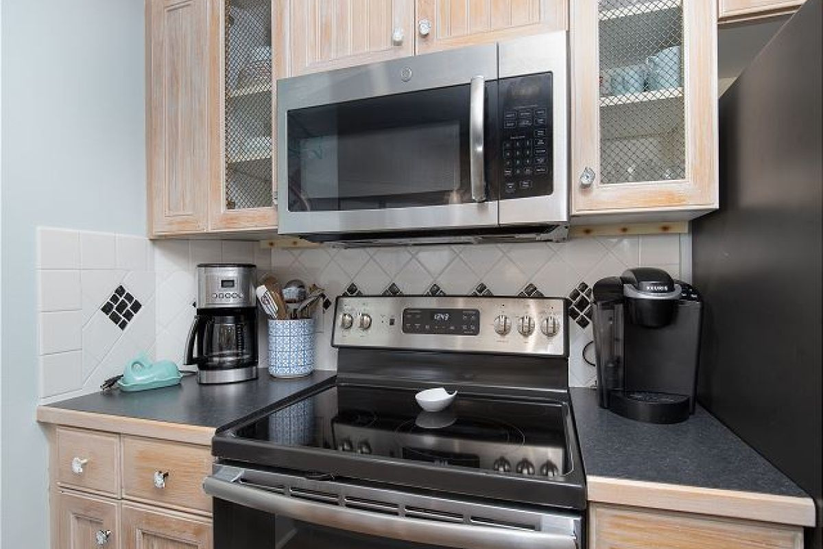 Kitchen range and microwave with Keurig and drip coffee maker on the counter