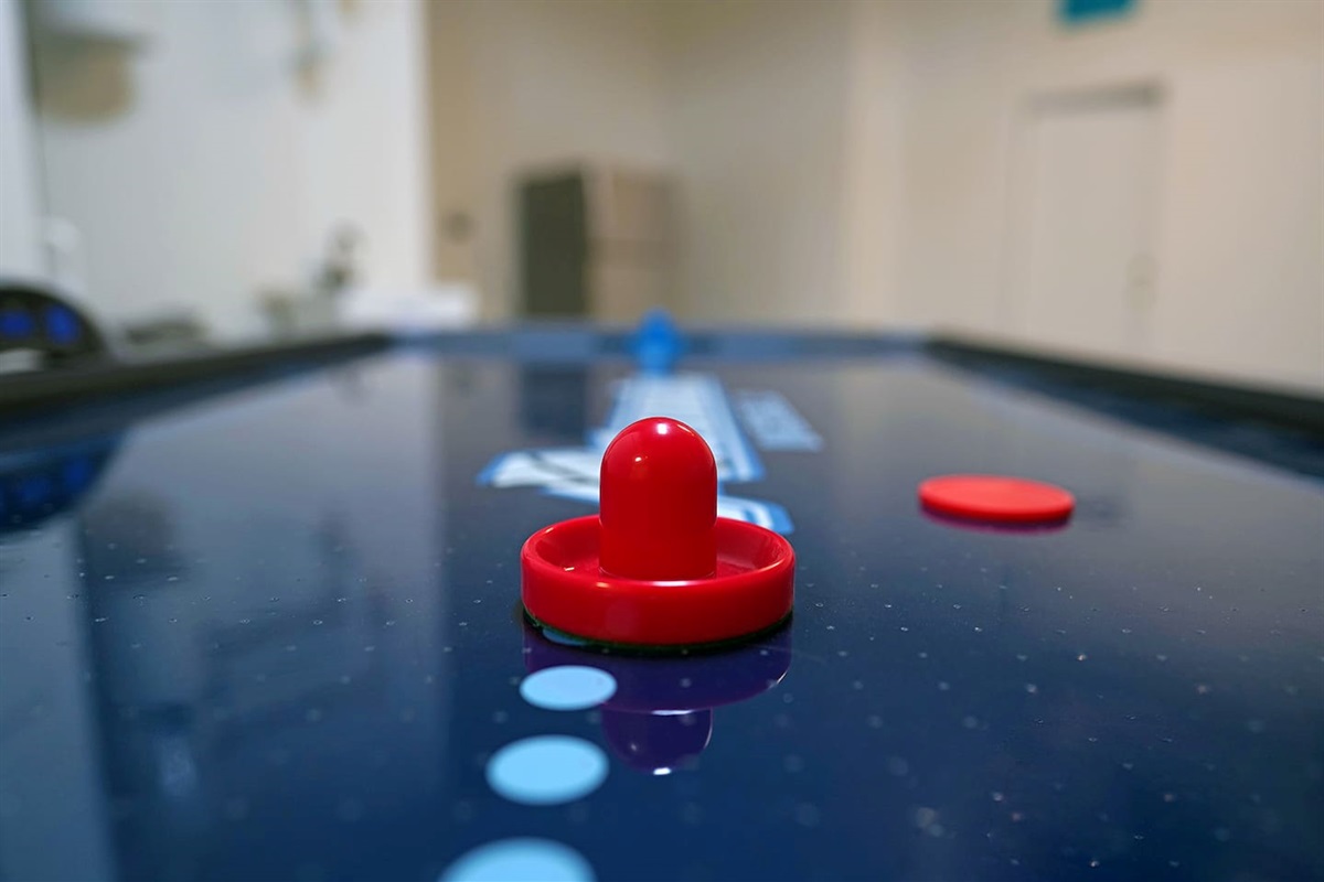 Air conditioned and heated garage space includes tons of games like foosball, air hockey, and shuffleboard.