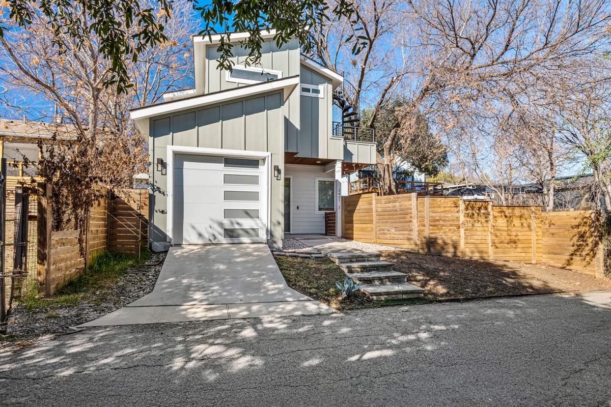 Modern exterior with private driveway and fenced yard
