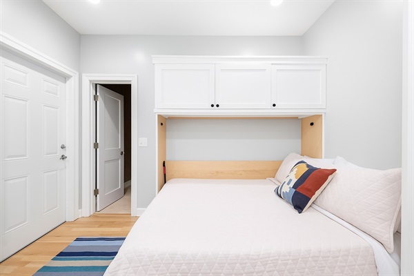 Main Level Full Murphy bed with adjoined half bathroom.