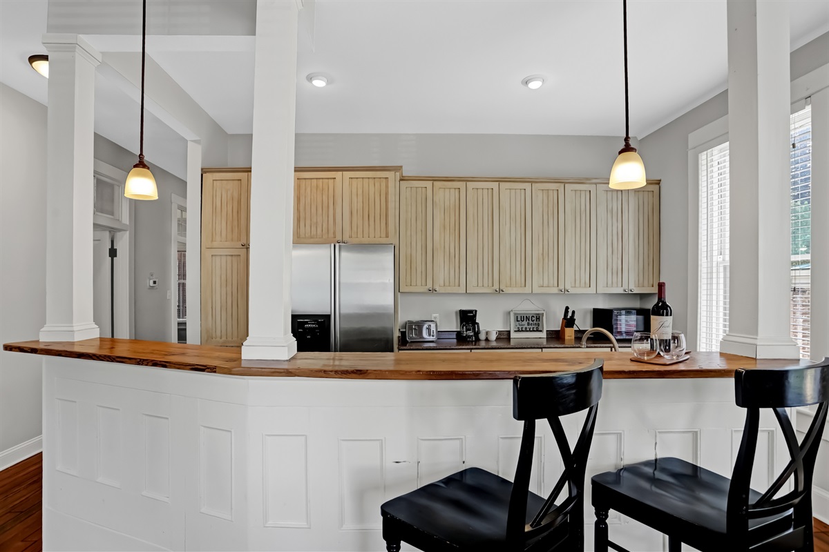 Pull up a barstool and enjoy casual meals or a glass of wine at the cozy kitchen island.