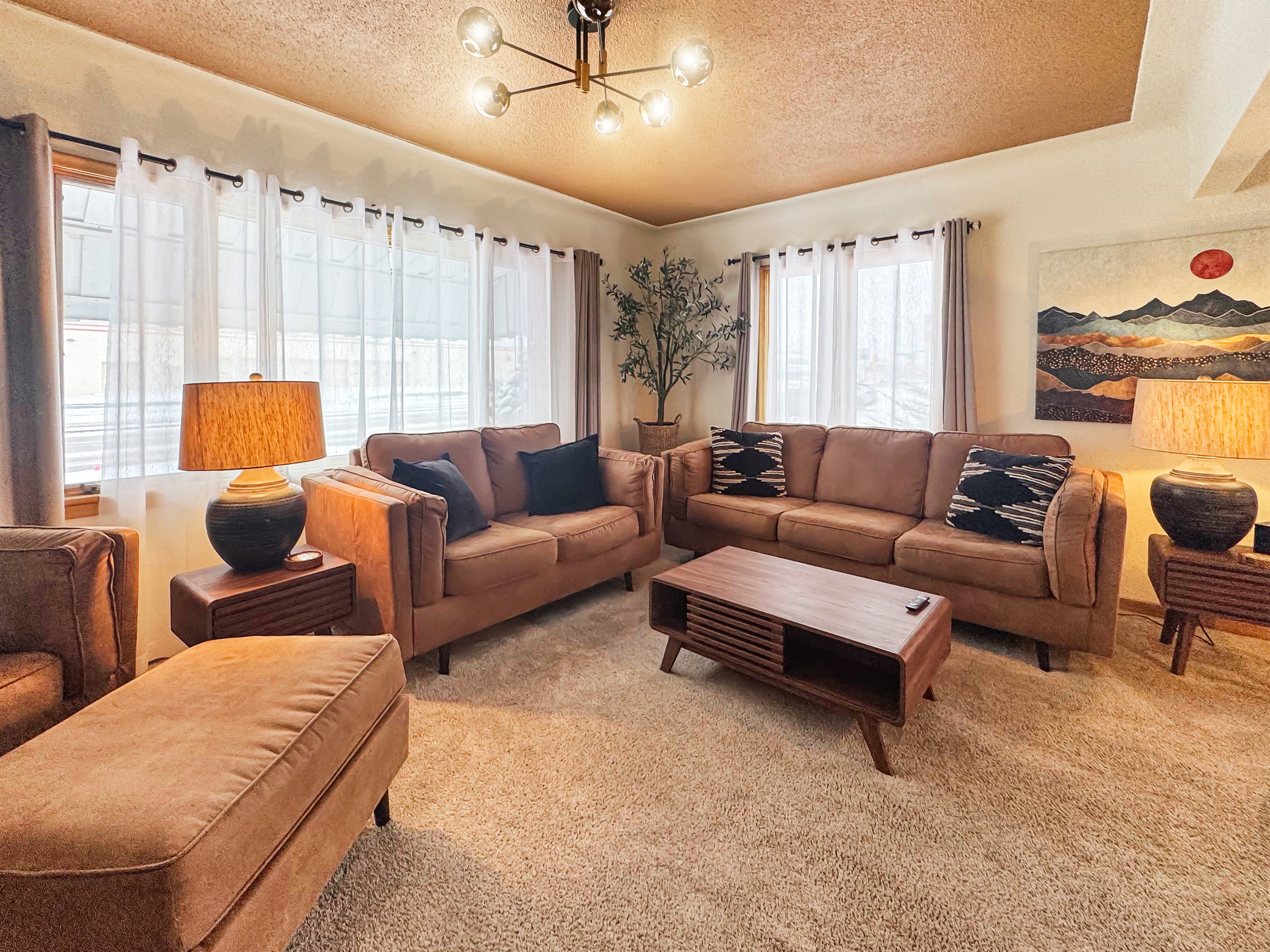 Gather here: 75" TV and plush seating for the perfect movie night