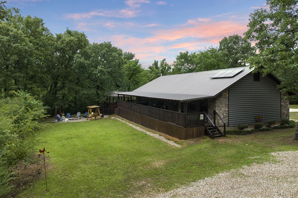 Great open area in front of covered porch for playing with the firepit at the end.