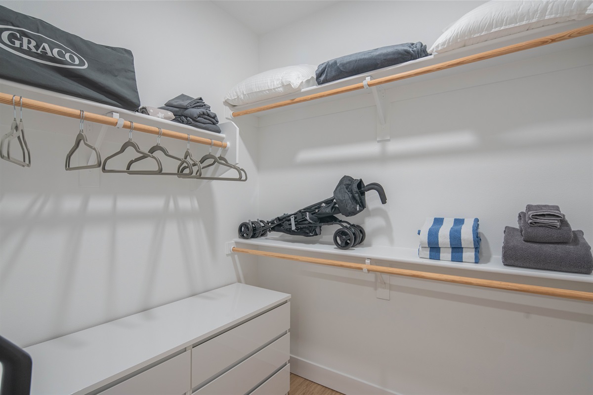 Spacious closet with ample storage, hangers, and family essentials for your stay.