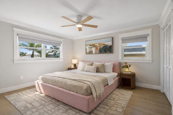 Bright guest bedroom with comfortable queen bed and natural light