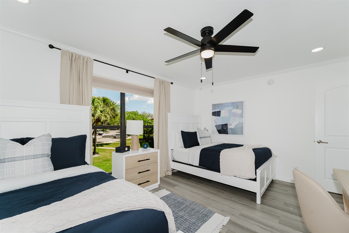 Cozy guest double queen bedroom with comfortable bedding and ample storage. Perfect space for family or friends to unwind and relax. Bright and inviting guest room with stylish touches.