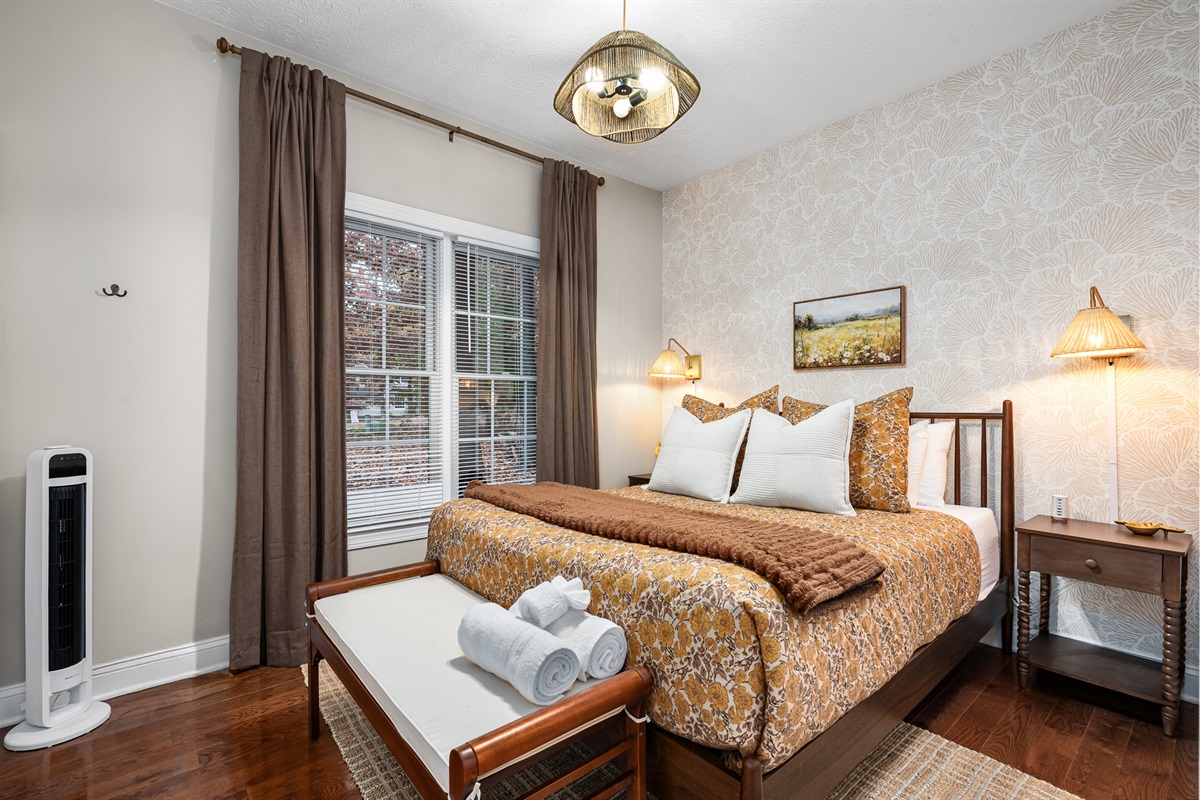 Sink into soft layers of bedding in this warm, golden-hued retreat. Perfect for a restful night after a day of mountain adventures.