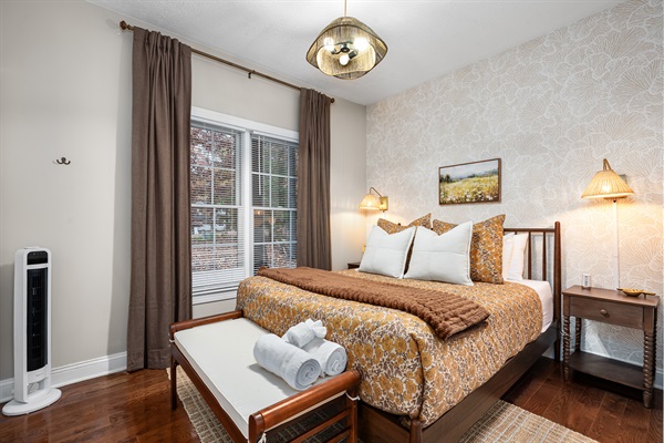 Sink into soft layers of bedding in this warm, golden-hued retreat. Perfect for a restful night after a day of mountain adventures.