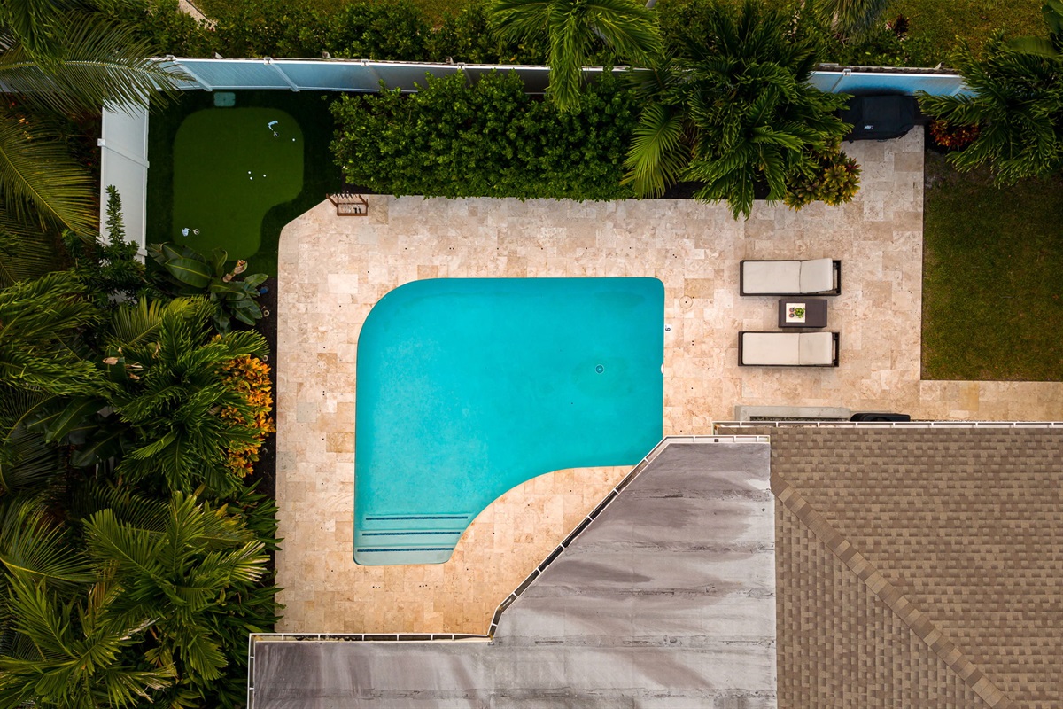 Your private oasis awaits &ndash; unwind in the serene outdoor pool surrounded by lush greenery, just steps from your stay.