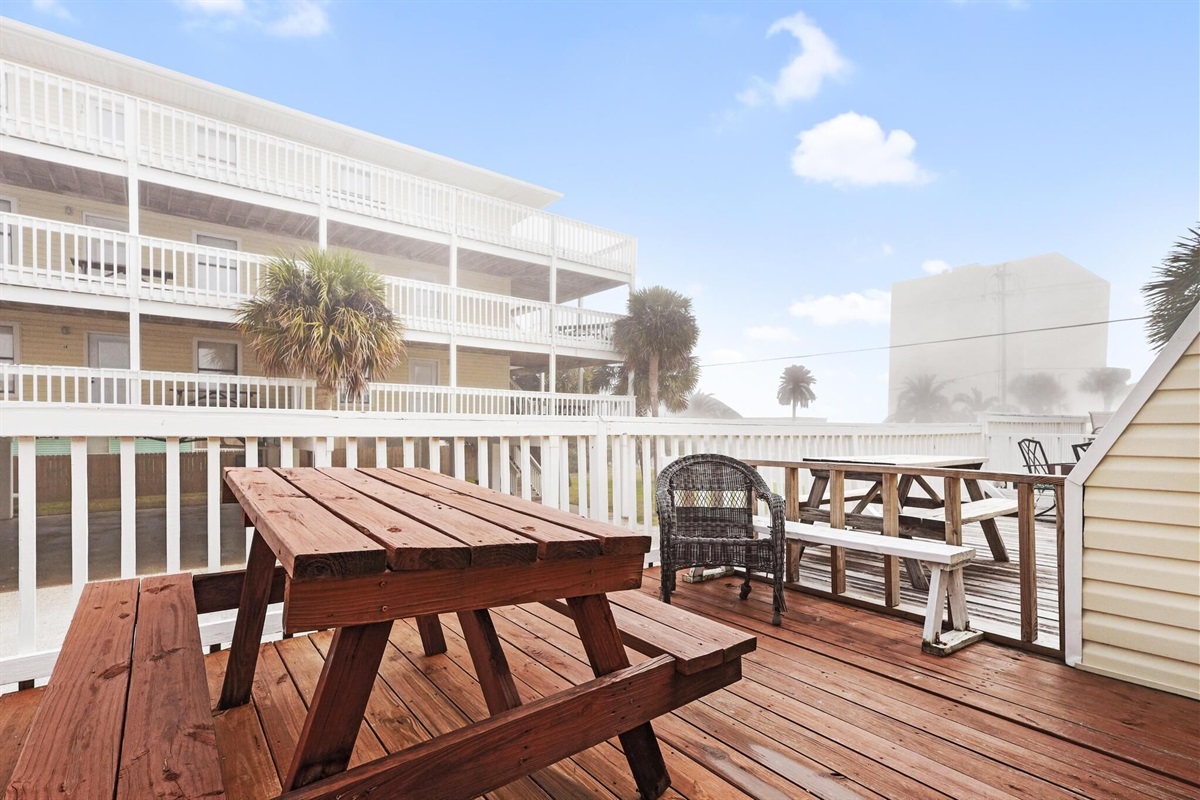 Balcony - The spacious balcony features seating, and a table for enjoying meals outdoors.