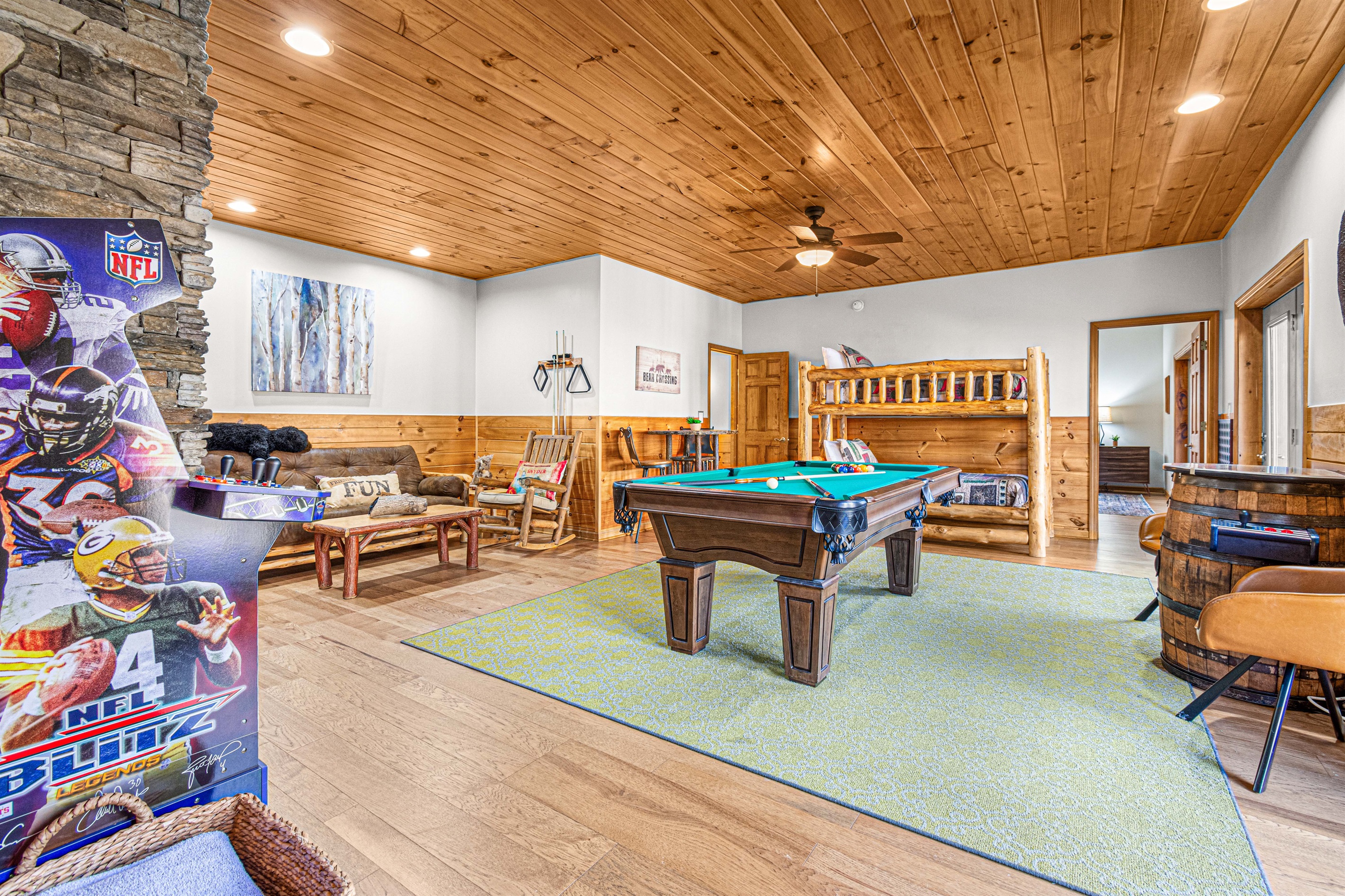 Pool table, arcade, table seating, deck access, & 55" TV = best game room!