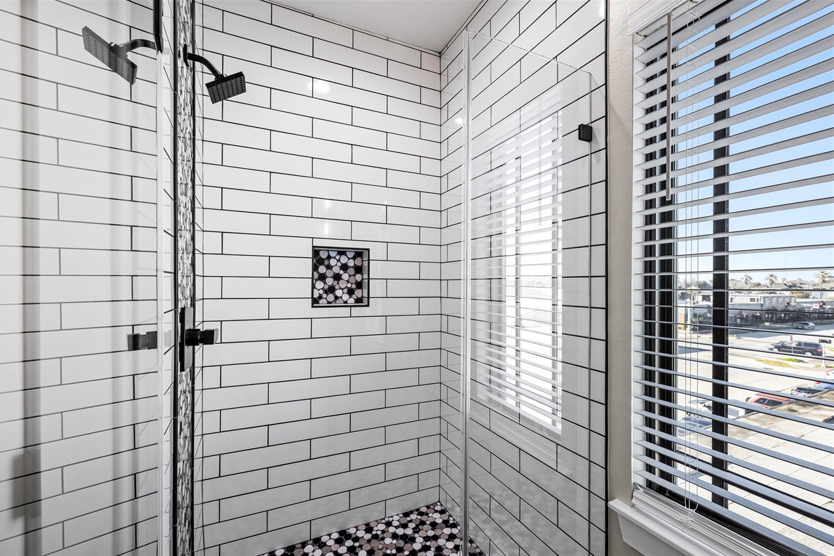 Guest Bathroom: Soak in style with a spacious shower and chic tile accents!