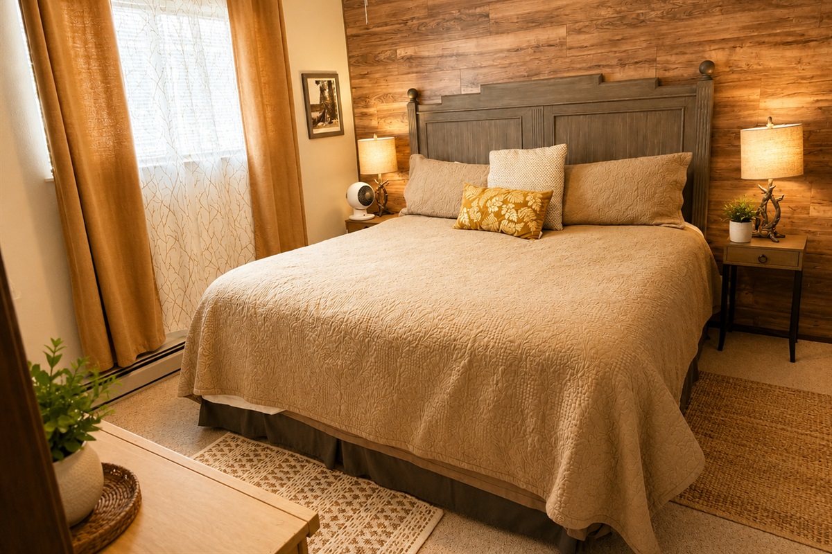 There are two bedrooms downstairs.  Both have king size beds and cozy linens.  There are nightstands and reading lights on both sides of the bed.  There is also a closet and dresser for storage.  The bedrooms also have baseboard heaters for added coziness.