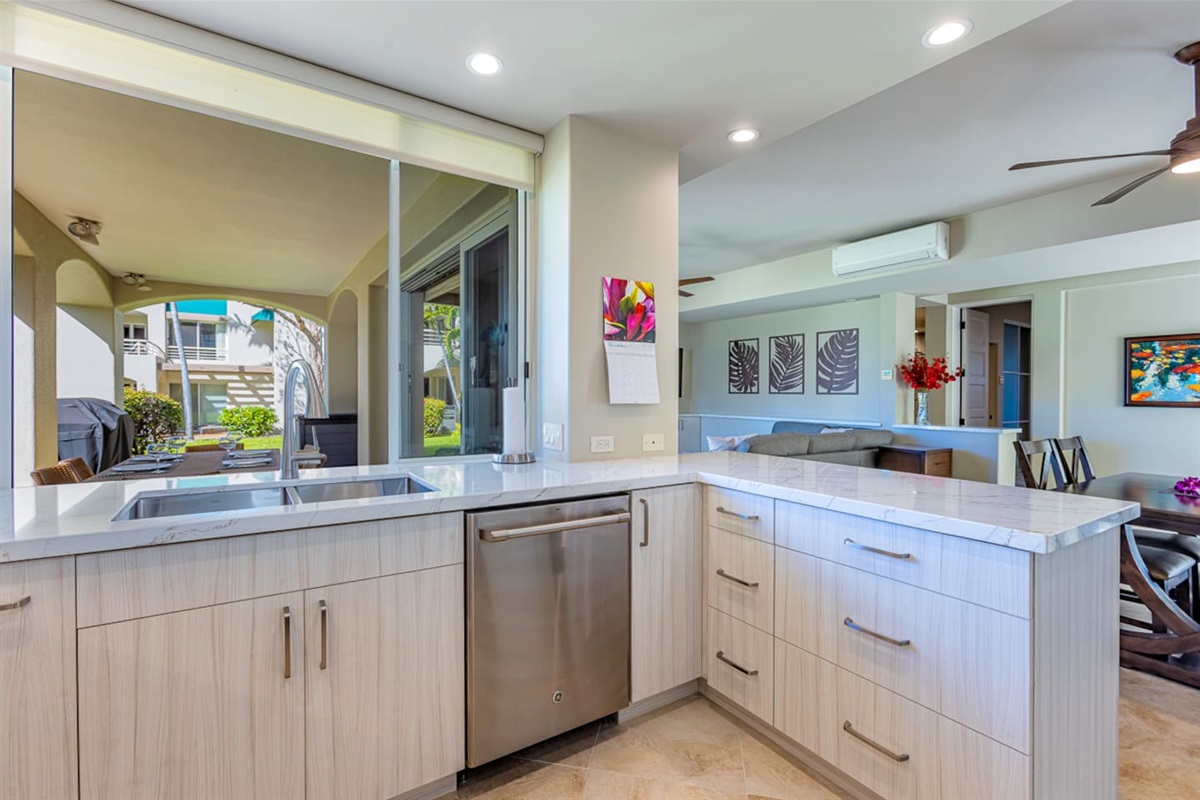 The large modern kitchen has a handy pass-thru window to the lanai. Note the BBQ was removed May 2024. There are now common area BBQs around property