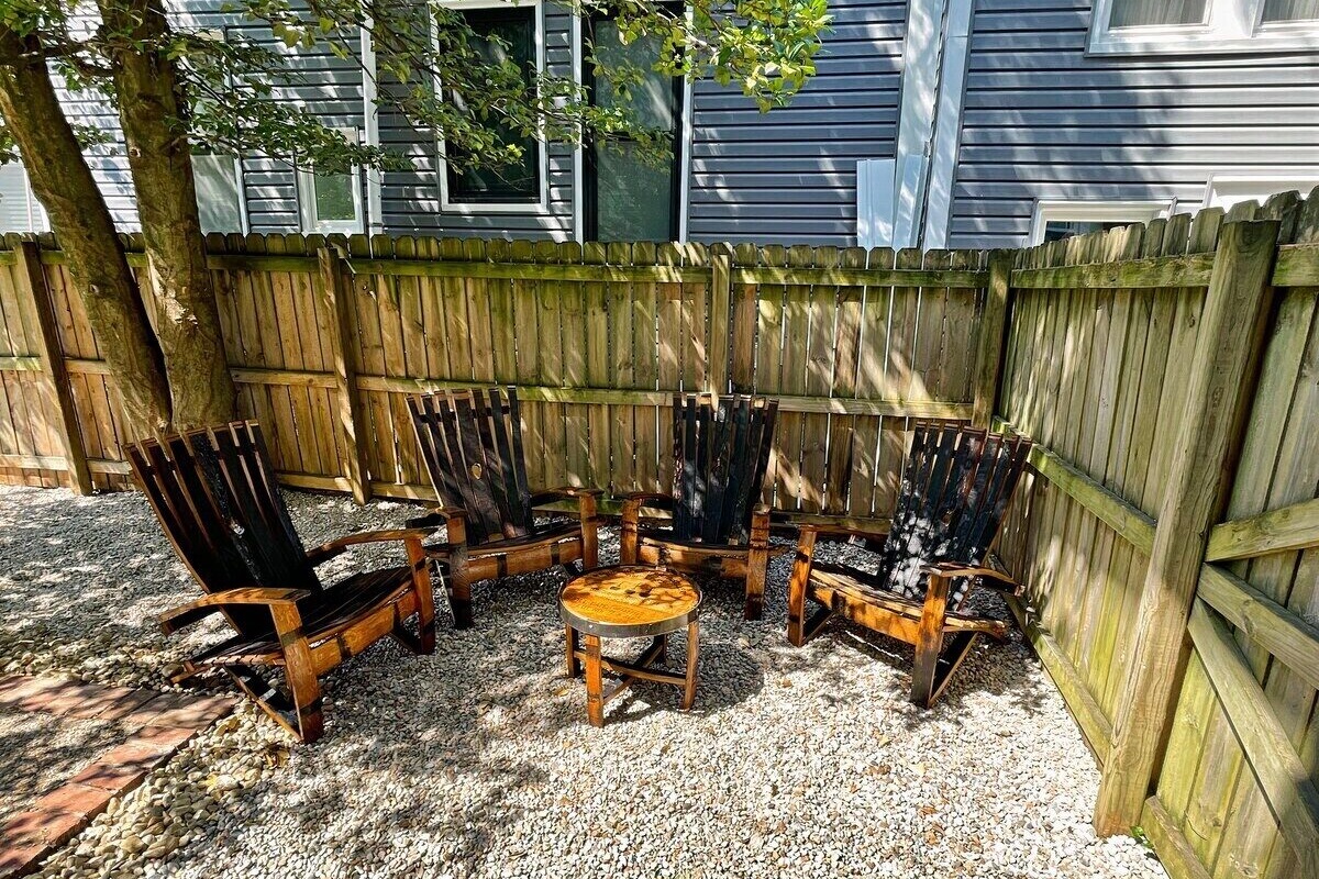 Sit back and relax on the pebble stone patio in our custom-made bourbon barrel Adirondack chairs. 