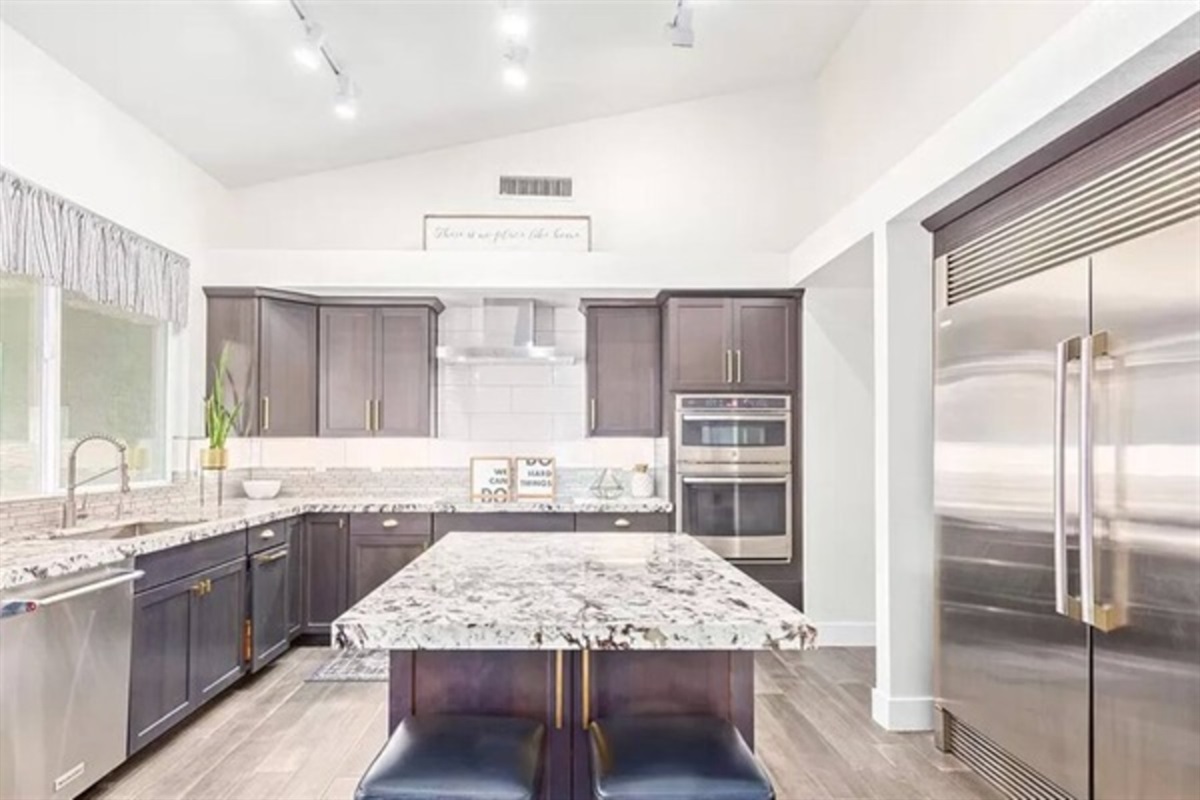 This chef-inspired kitchen offers high-end finishes, double ovens, and a huge island perfect for family meals and entertaining.