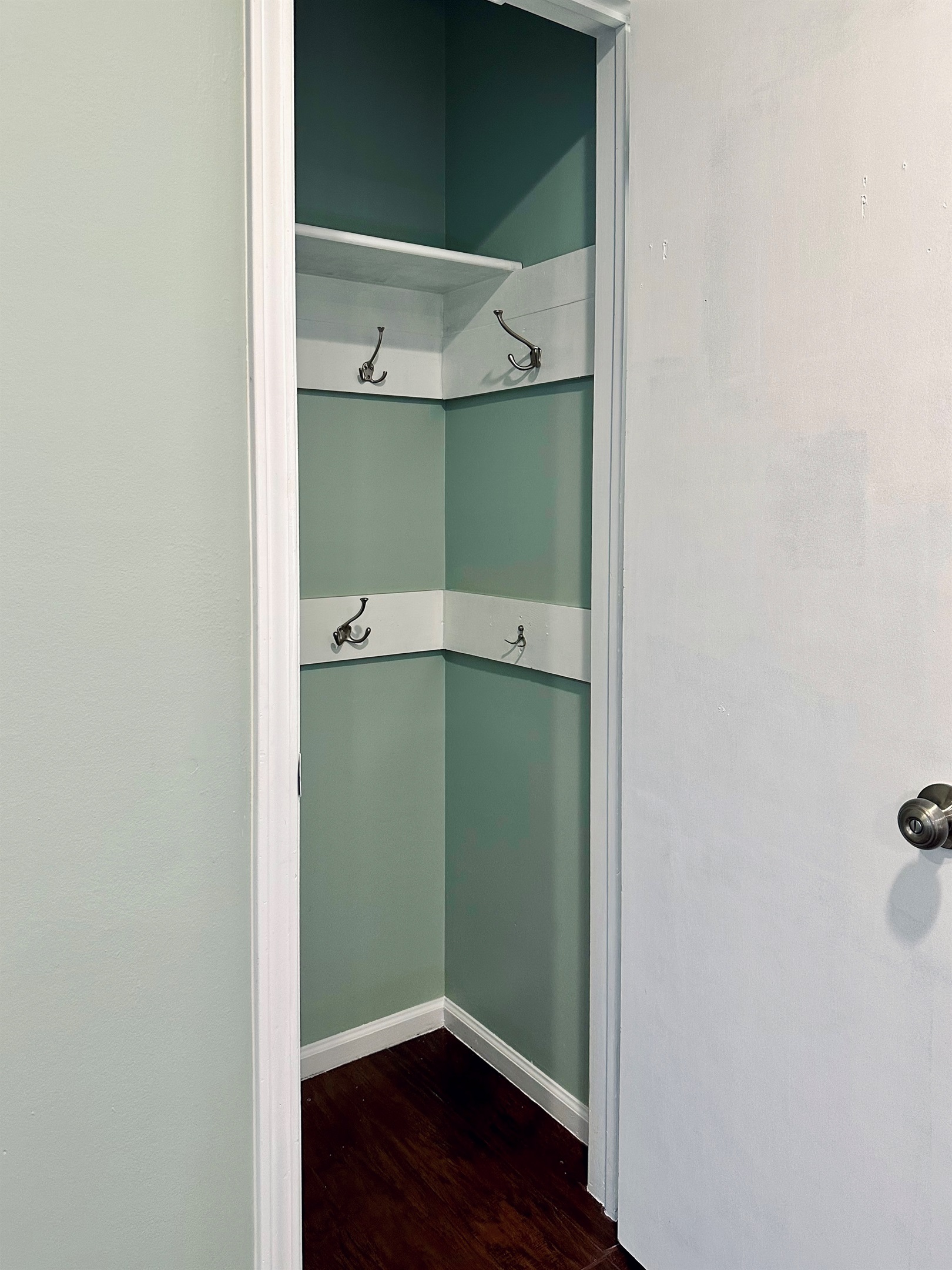 Spacious Entry coat closet with wall-mounted hooks and shelving, perfect for jackets, bags, and daily essentials. An easy drop zone that keeps the main living area uncluttered and organized.