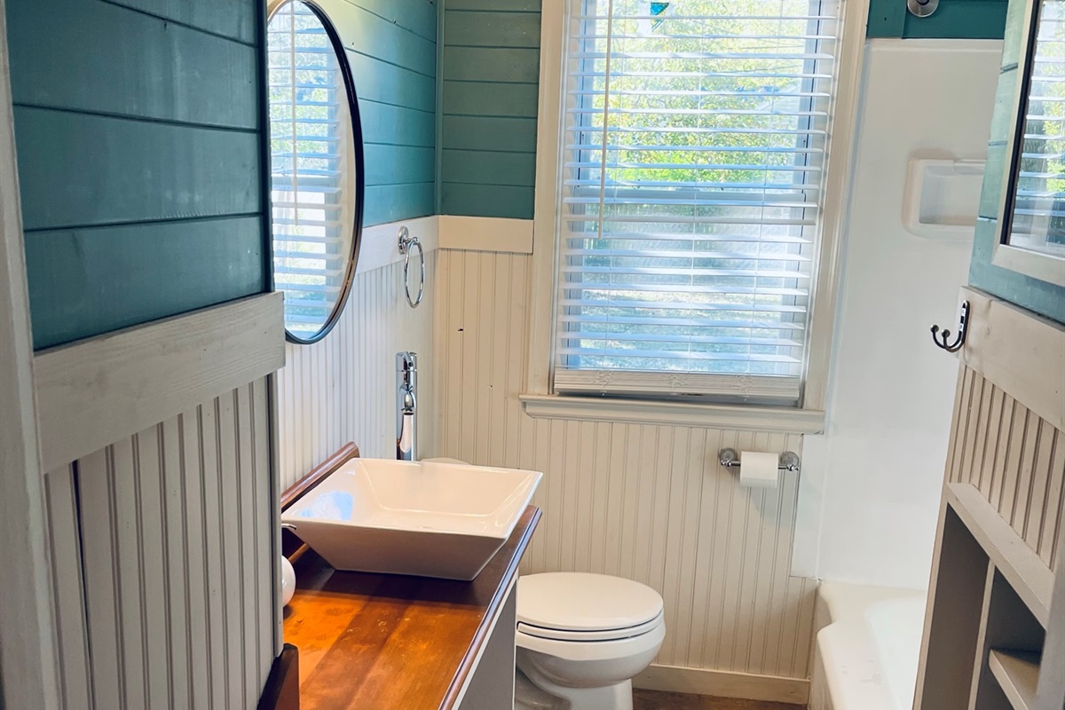 A full bathroom with plenty of light.