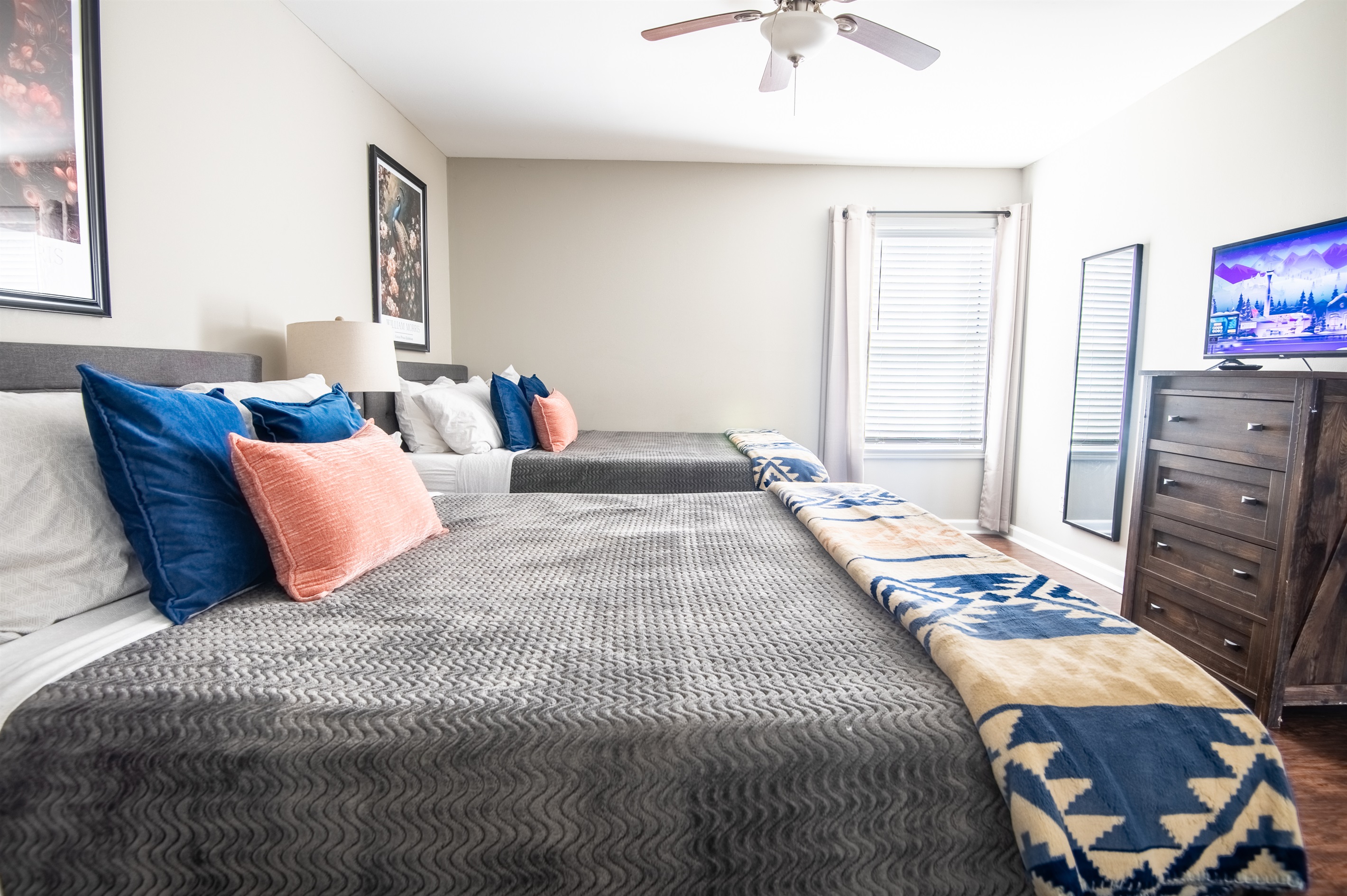 The double queen bedroom on the left in Unit B is thoughtfully designed for coziness and the best streaming nights!