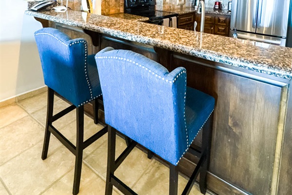 Fully equipped kitchen with breakfast bar seating for two.