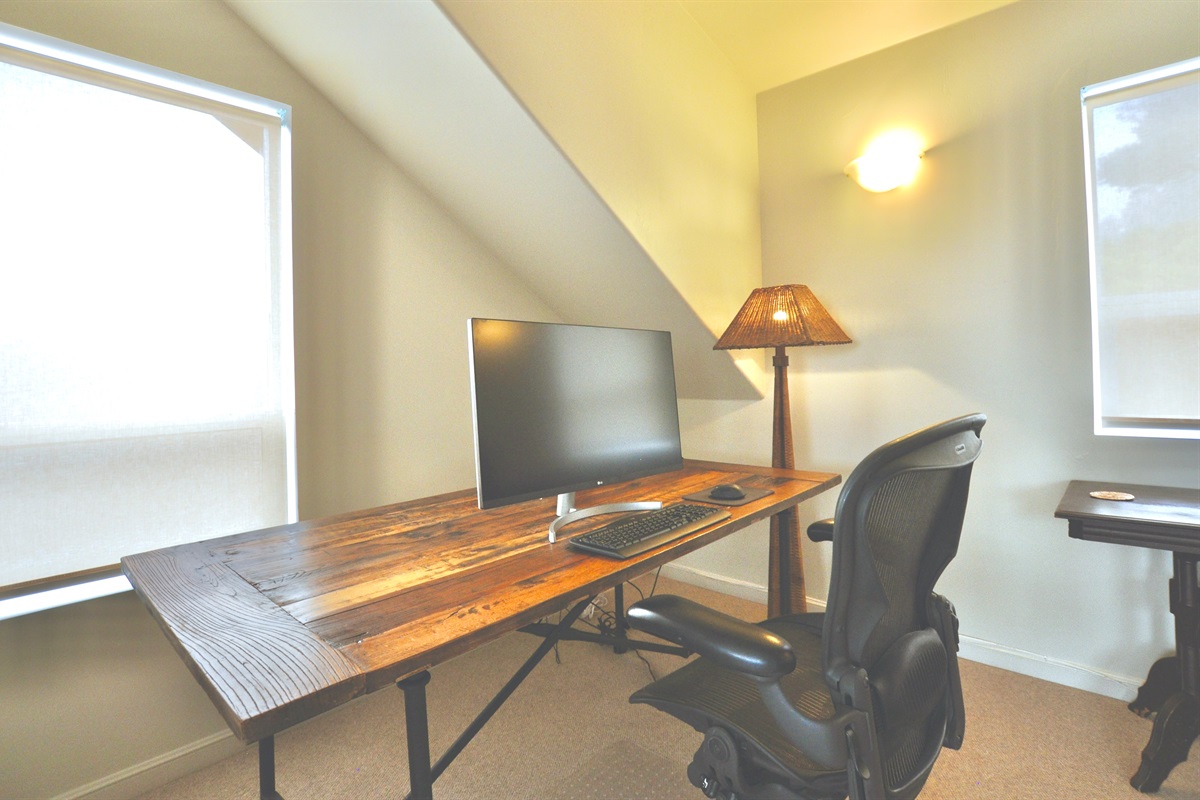 Full desk, office chair and monitor in the office/bedroom, with ocean views