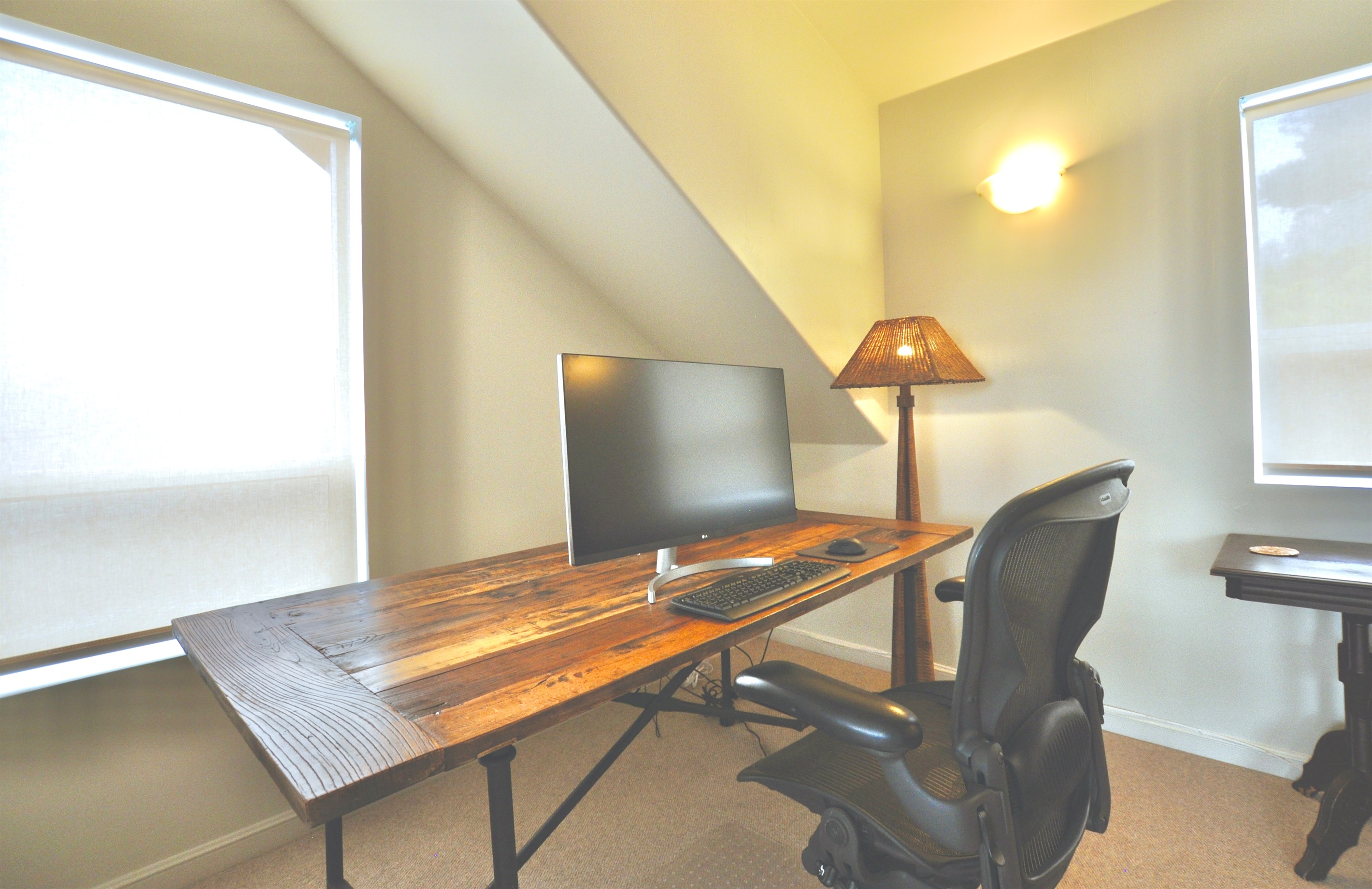 Full desk, office chair and monitor in the office/bedroom, with ocean views