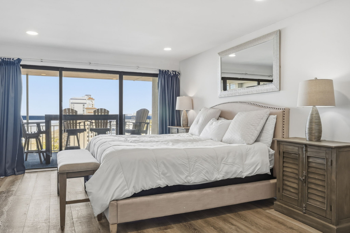 Primary bedroom king bed with balcony access