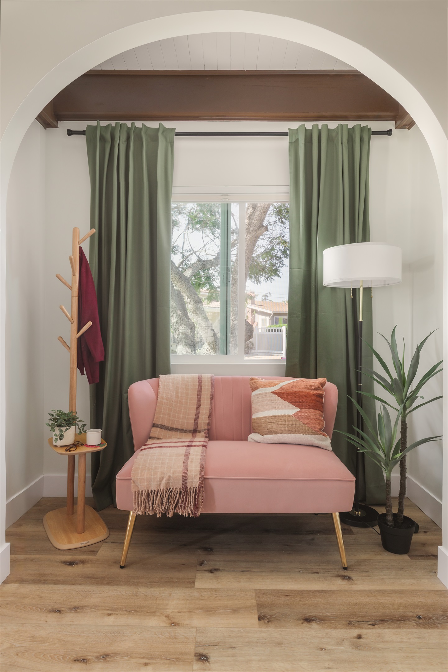 Start your morning with coffee and sunlight in this dreamy reading nook, where cozy textures, soft colors, and leafy views create a peaceful escape