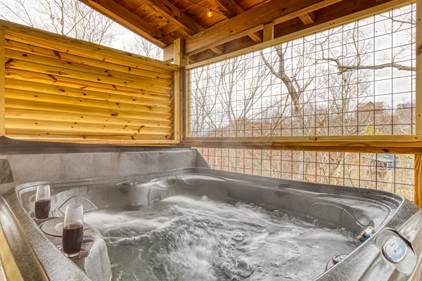 Enjoy a warm soak in the private hot tub while you listen to the breeze move through the trees