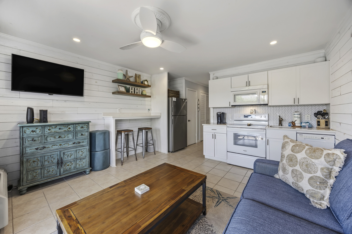 Living room with queen sofa sleeper, open to kitchen
