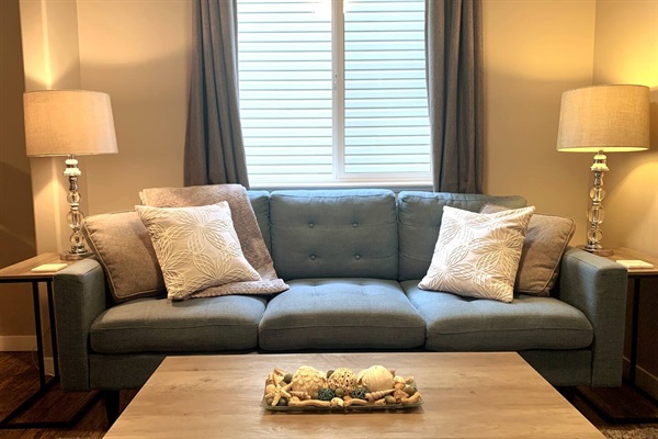 Living room with comfortable couch and rocking chair.