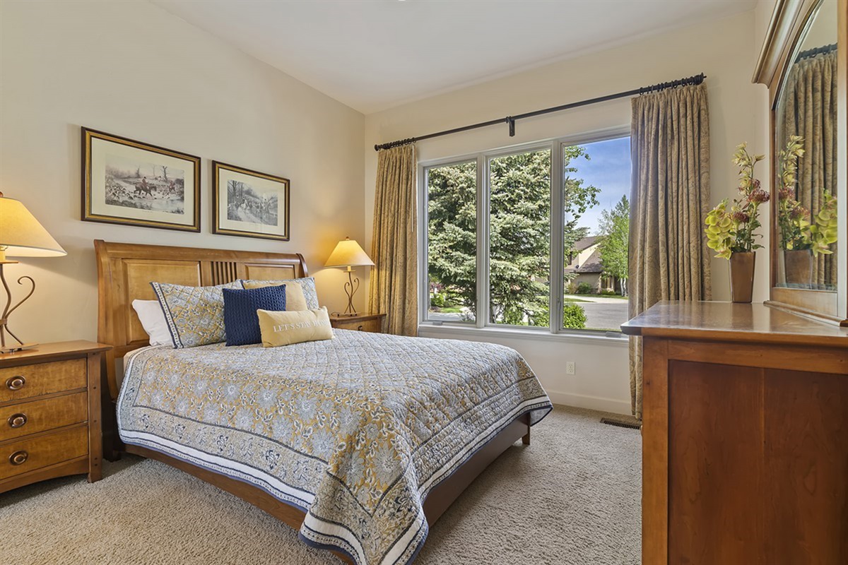 Comfortable queen bedroom with peaceful natural light