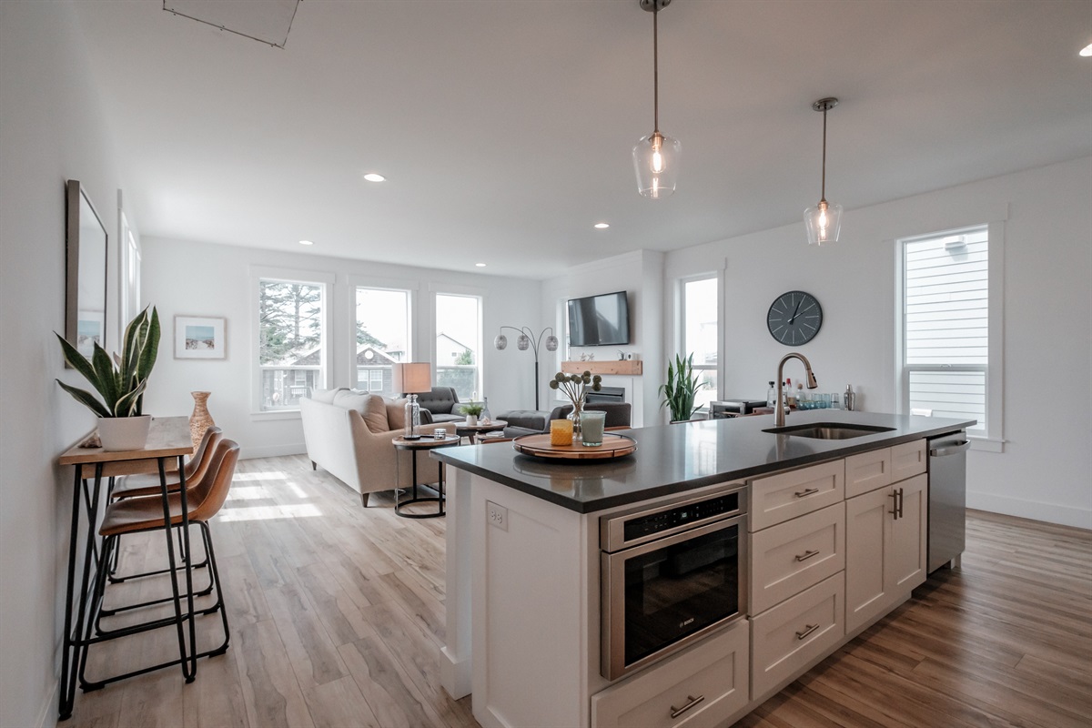A fully equipped kitchen with stainless-steel appliances, and additional seating,   thoughtfully designed for effortless hosting.