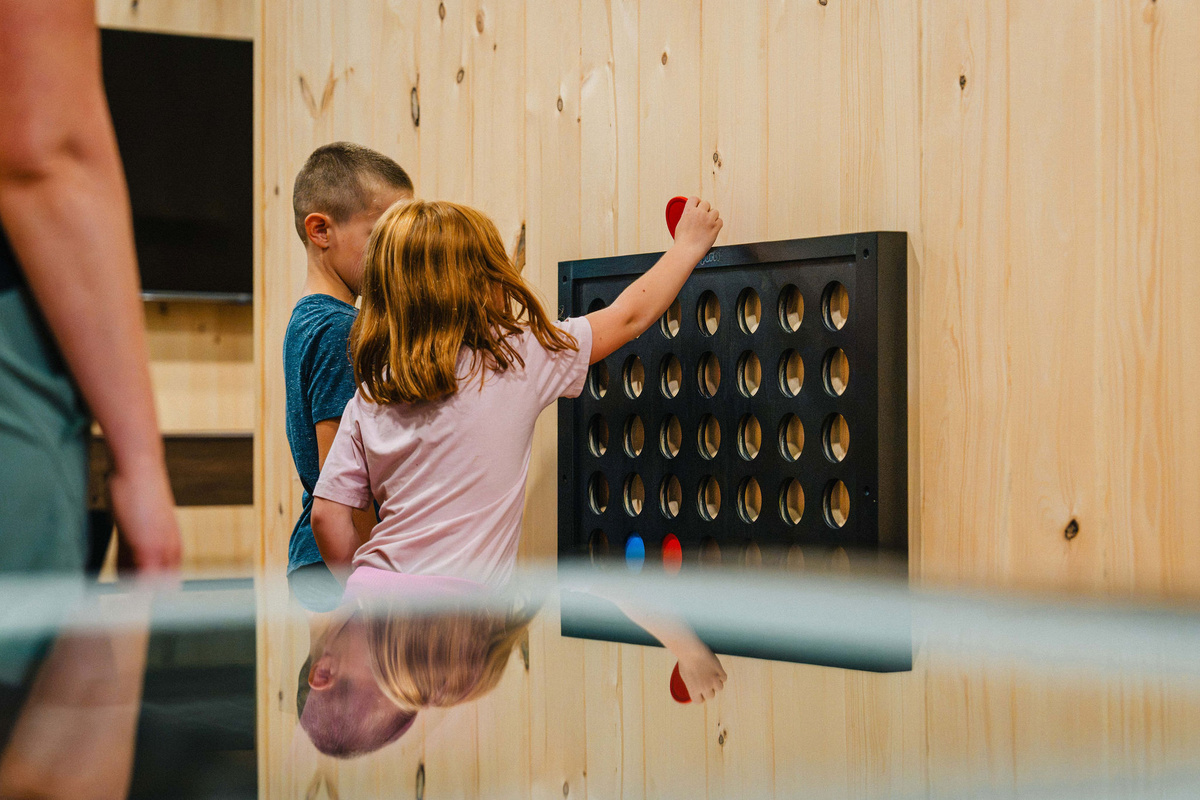 🔴 Wall-mounted Connect 4 — quick games while you wait your turn.