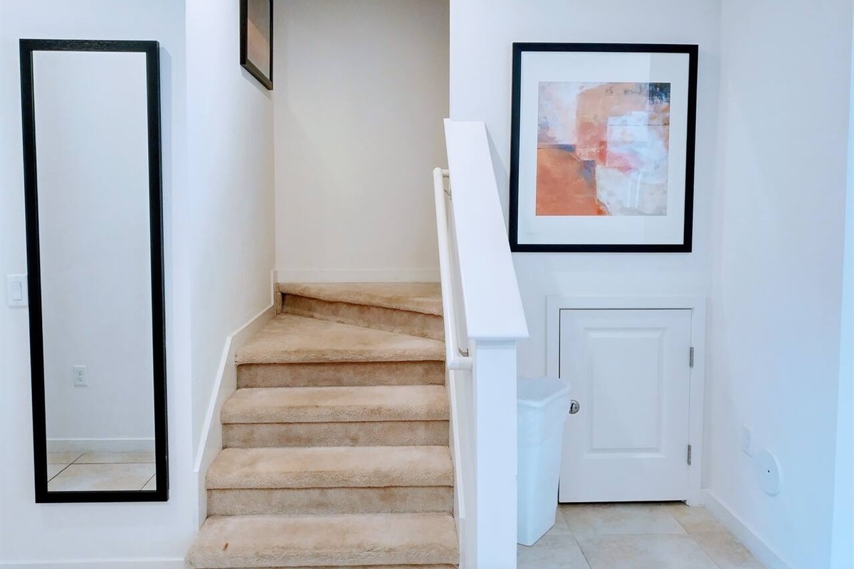 The stairs leads to the upper floor, where the two ensuite bedrooms are located
