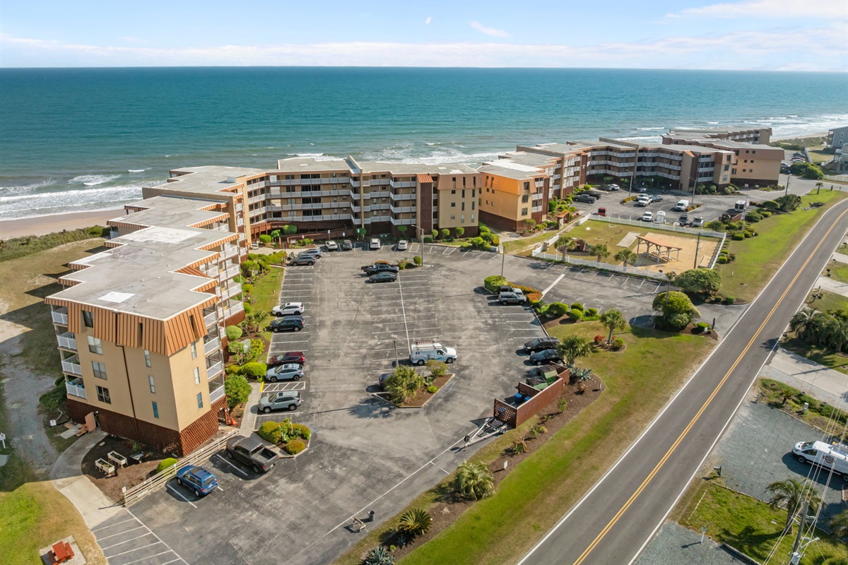 Full community view highlighting ample parking, on-site amenities, and easy beach proximity