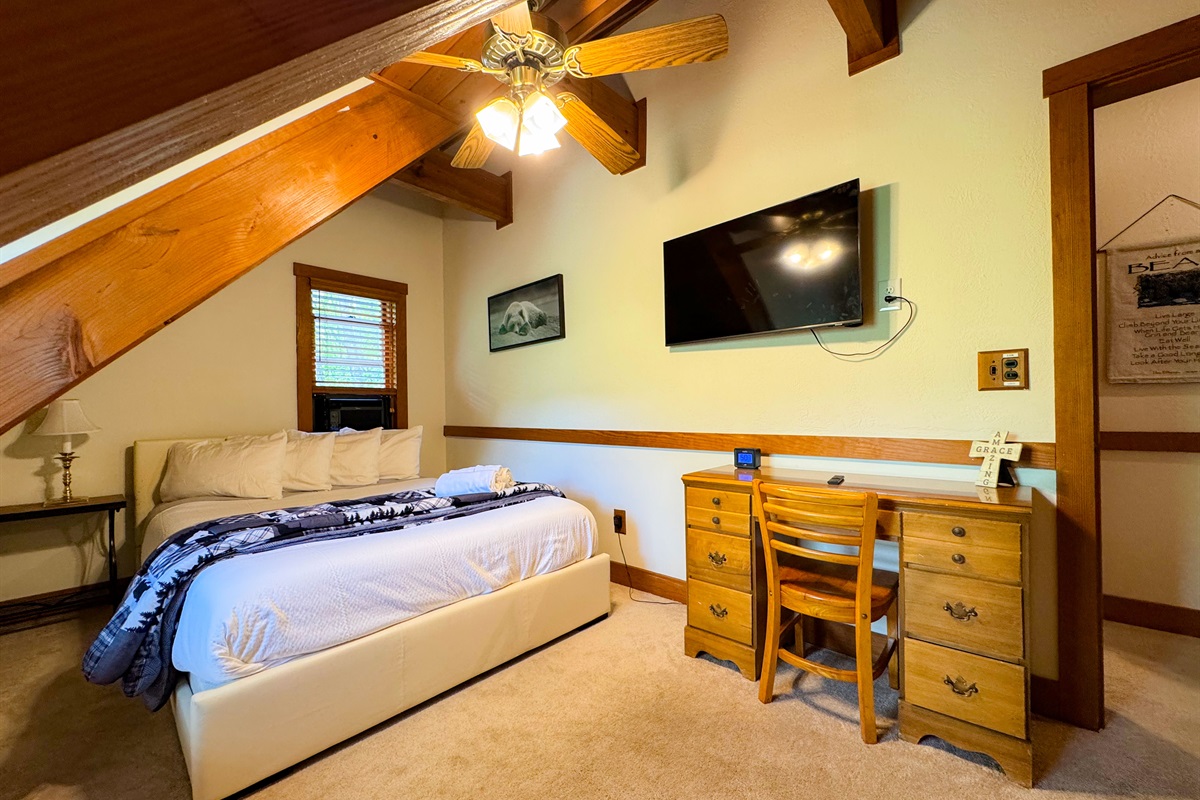 The upper level bedroom has a queen size bed and its own TV