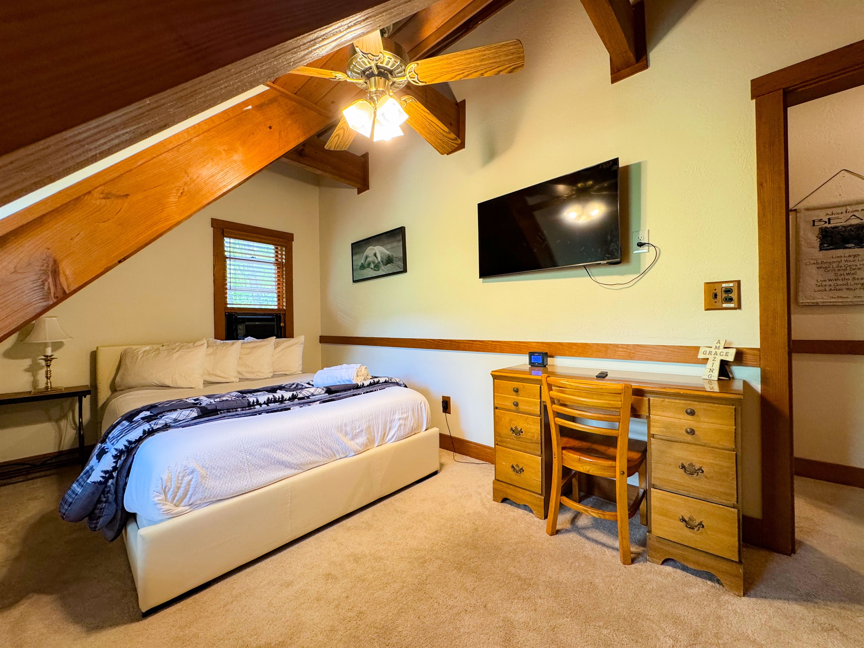 The upper level bedroom has a queen size bed and its own TV