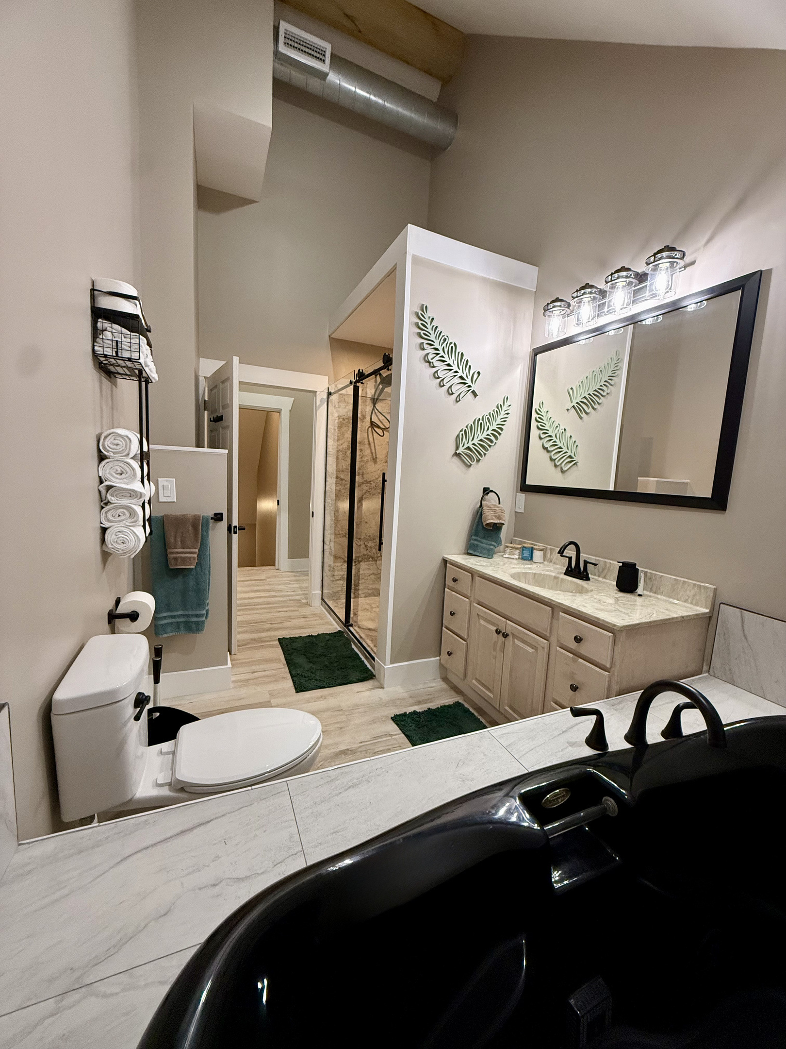 Master bath stocked with shampoo, conditioner, body wash, Q-tips, make-up remover wipes, make-up pads, hand soap, and hand lotion. 