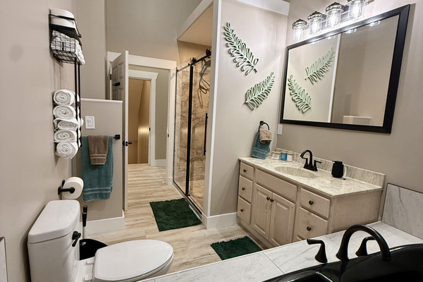 Master bath stocked with shampoo, conditioner, body wash, Q-tips, make-up remover wipes, make-up pads, hand soap, and hand lotion. 