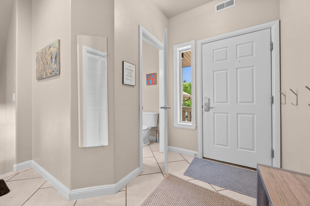 Welcoming entryway with convenient hooks, bench seating, and easy access to the outdoor deck and living spaces — perfect for coming and going after a day of adventure.